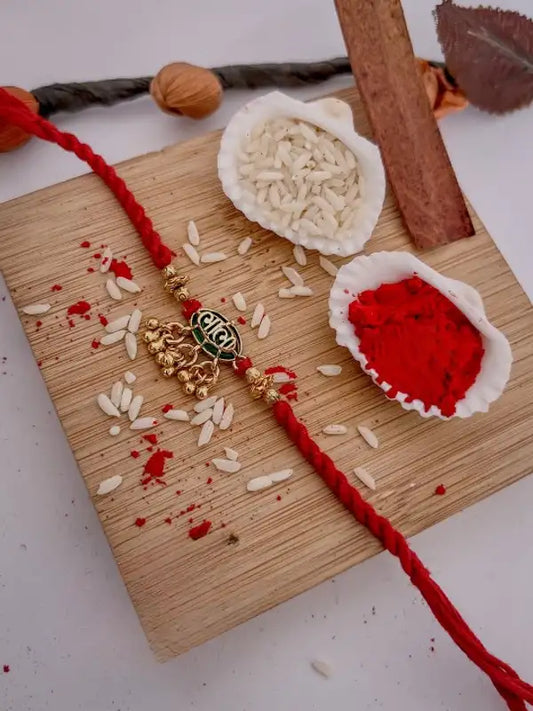 Traditional Gold-Plated Designer Bhabhi Rakhi with Red Mauli Thread